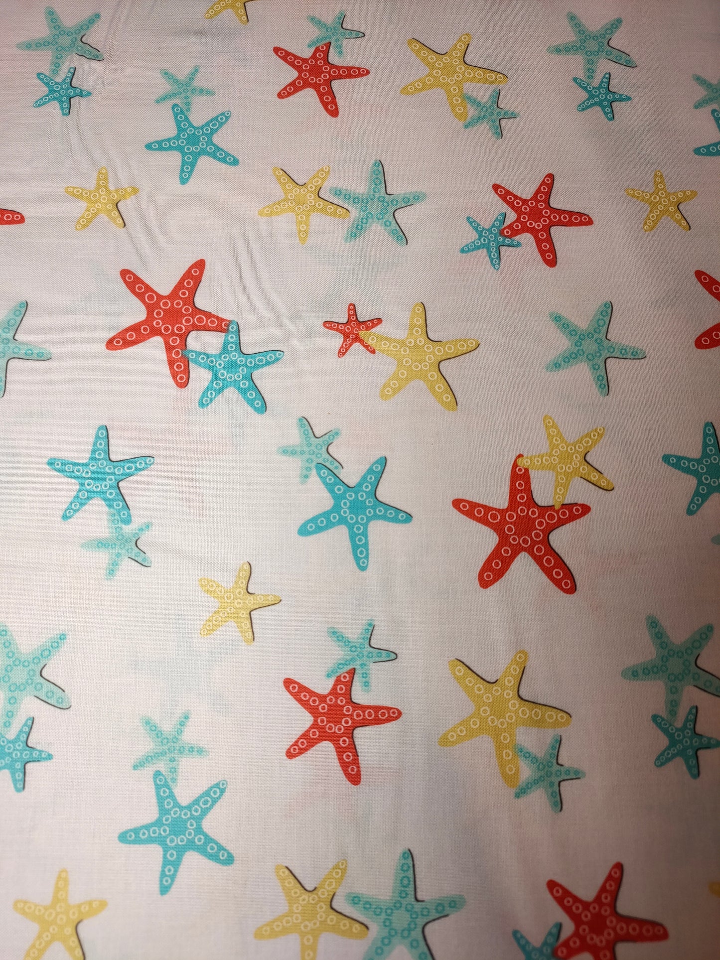 Michael Miller A Sea Of Stars 100% cotton fabric. Far Quarter. Starfish on a White Background