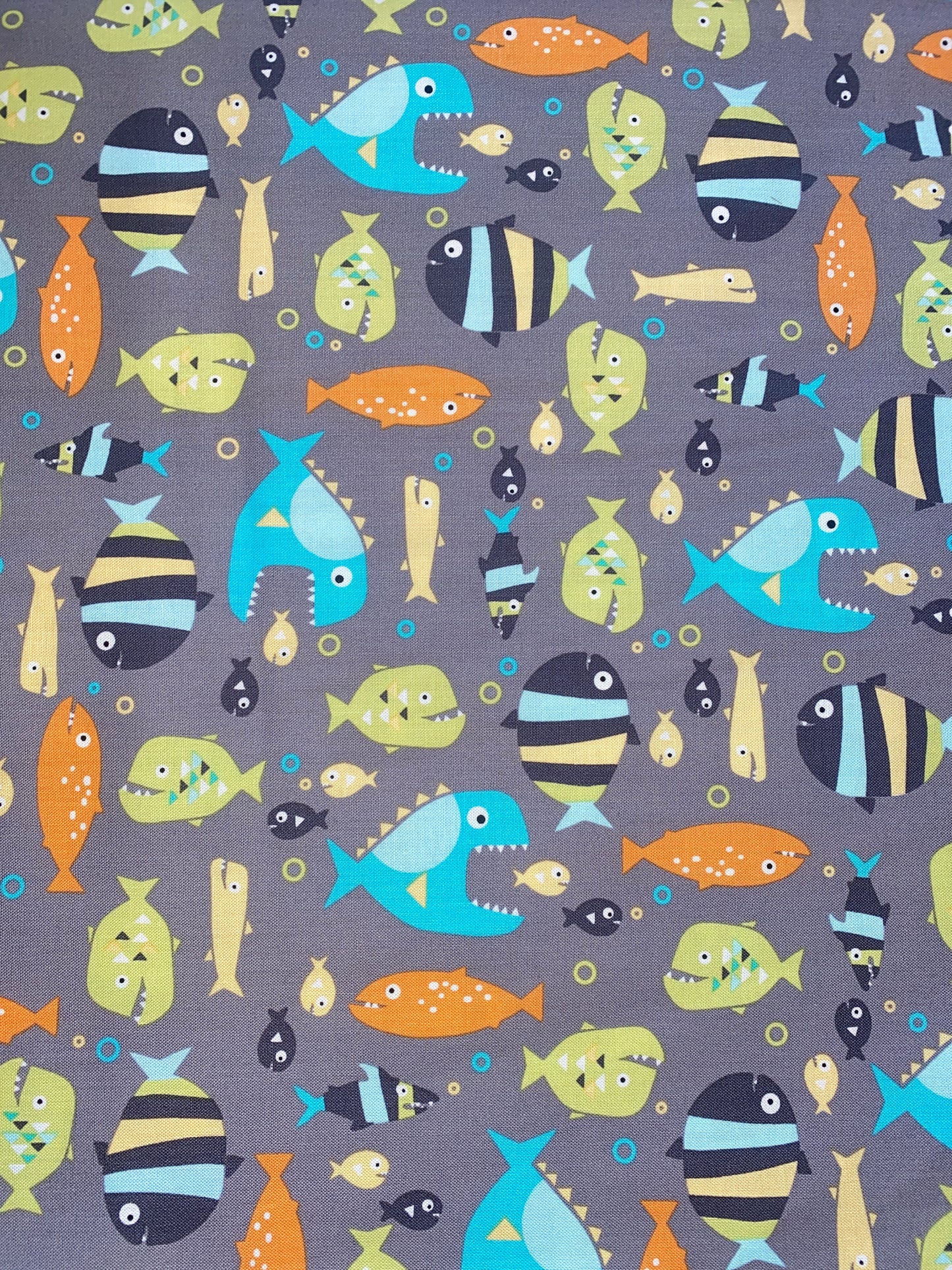Michael Miller Piranhas 100% cotton fabric. Fat Quarter. Piranhas and fish on a grey background.