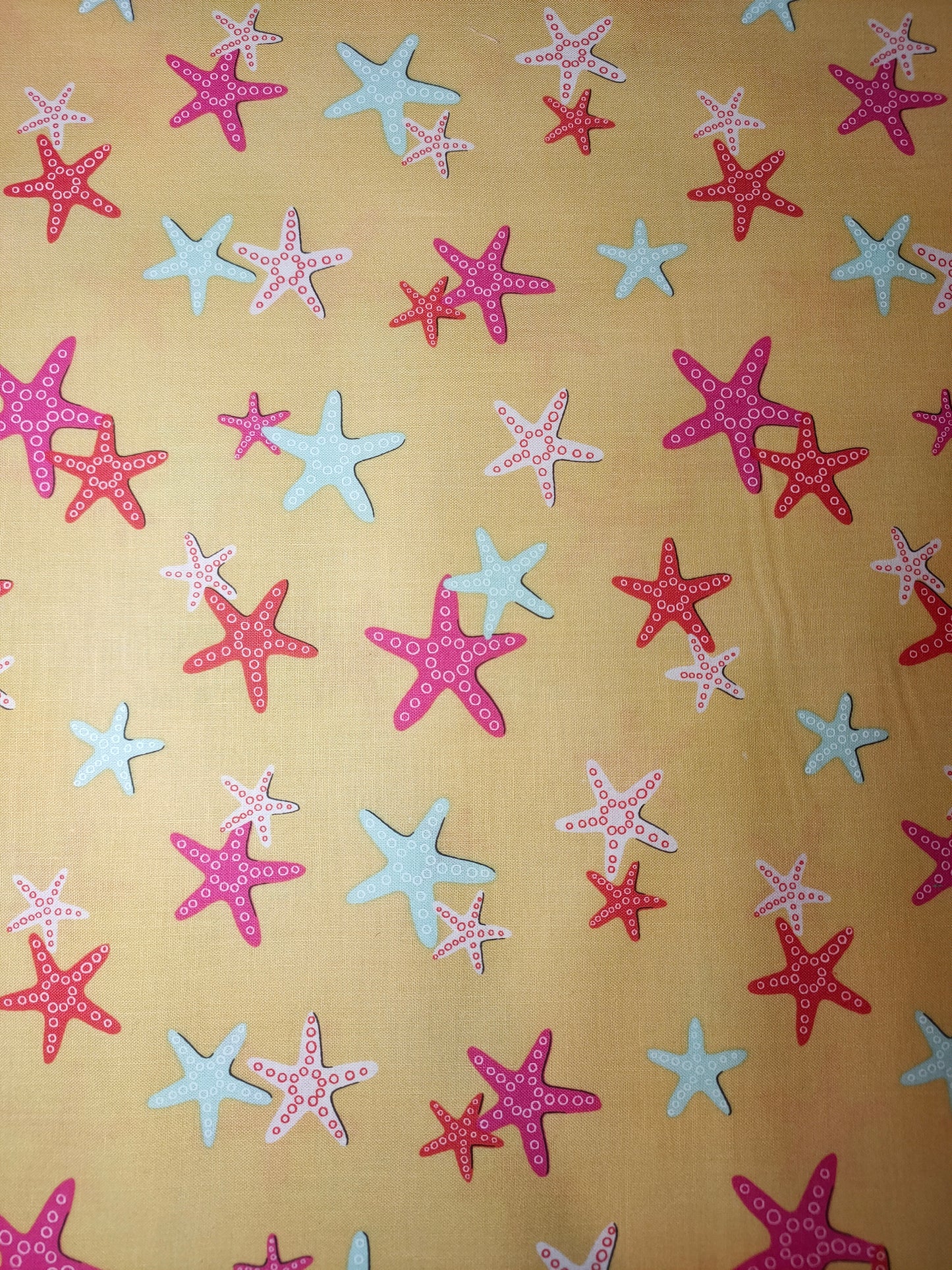 Michael Miller A Sea Of Stars 100% cotton fabric.  Yellow with Pink and Blue Starfish
