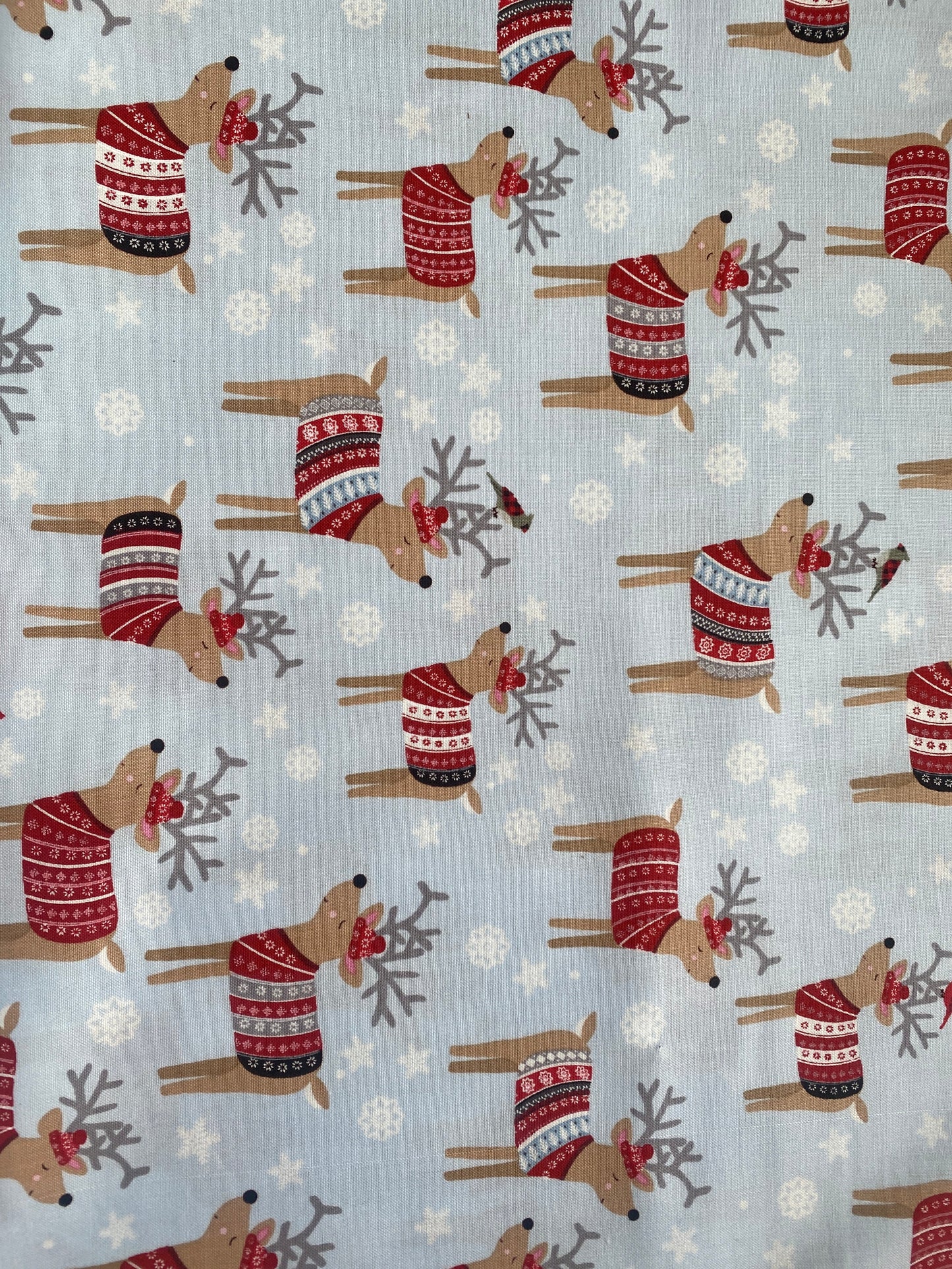 Studio e Snow Delightful 100% cotton fabric. Fat Quarter.  Reindeer in Christmas jumpers and hats on a snowy pale blue background.